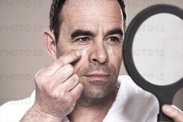 Man applying eye pads