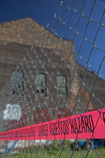 A warning of an asbestos hazard at the old Globe Trading Company building