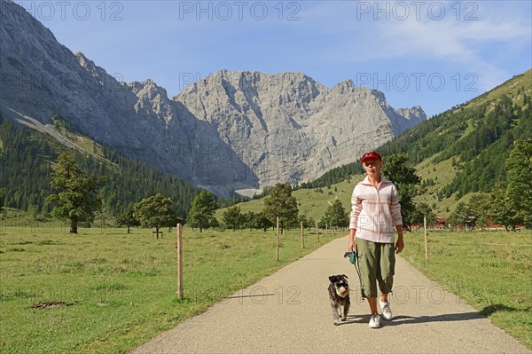 Woman hiking with a Miniature Schnauzer