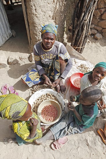 Children peeling peanuts