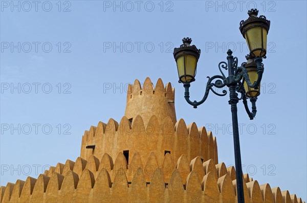 A tower of the Al Ain Palace Museum or Sheikh Zayed Palace Museum and a street lamp