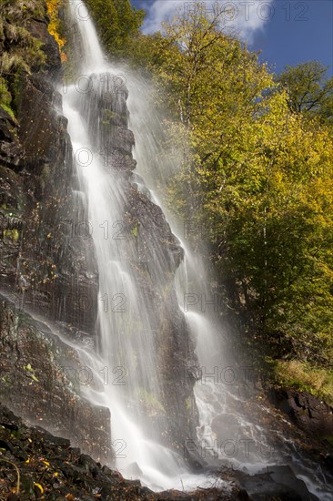 Waterfall in an autumnal landscape in Trusetal
