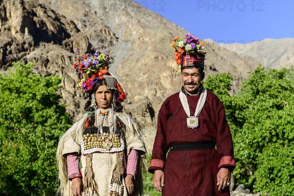 A couple of the Brokpa tribe wearing traditional dresses with flower headdresses