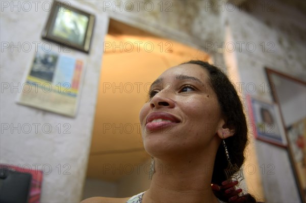 Woman in a mouldy apartment in a slum or favela