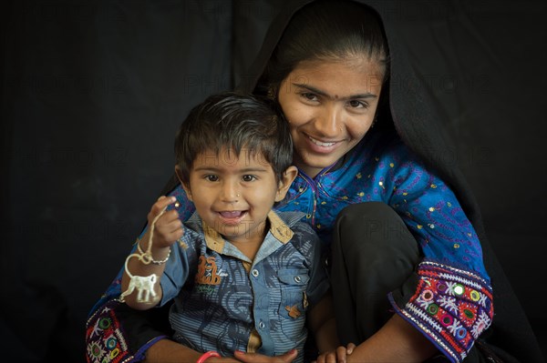 Young Rabari Woman with child in traditional clothes