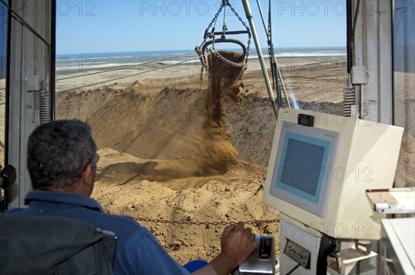 Excavator operator in the cab of a dragline excavator working in the diamond mine of De Beers Namaqualand Mines