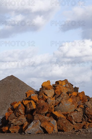 Stack of rusty ferruginous rocks waiting to be recycled