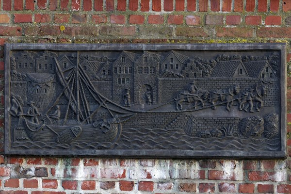 Townscape with a horse drawn boat and draught animals