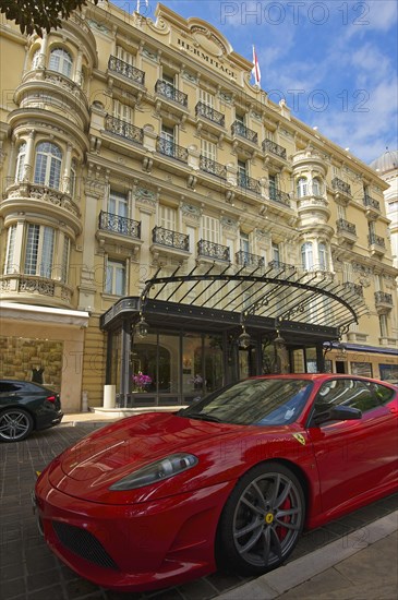 Red Ferrari parked in front of the Hermitage Hotel