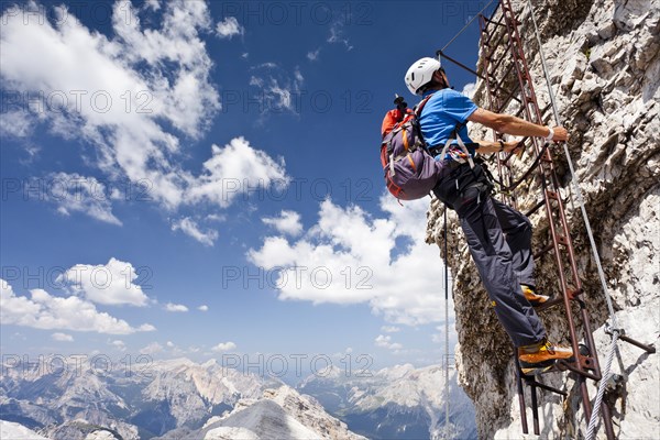 Climber ascending Monte Cristallo via the Via ferrata Ivano Dibona climbing route