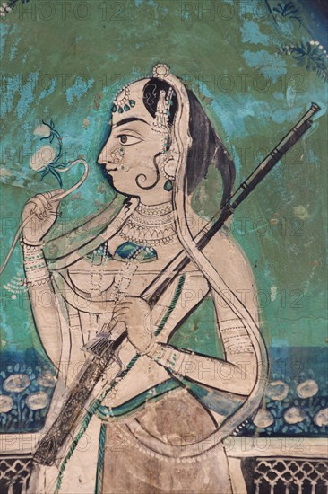 Woman holding a gun and a flower