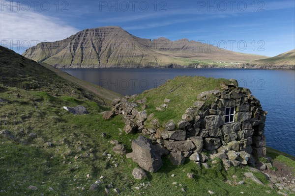 Old stone house on a fjord