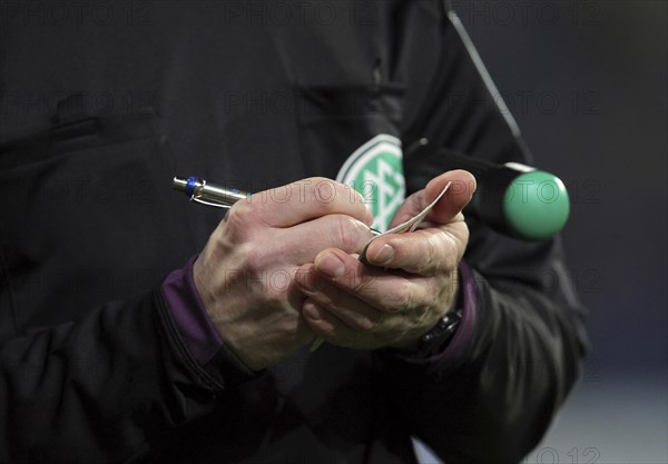 A German assistant refereee taking notes