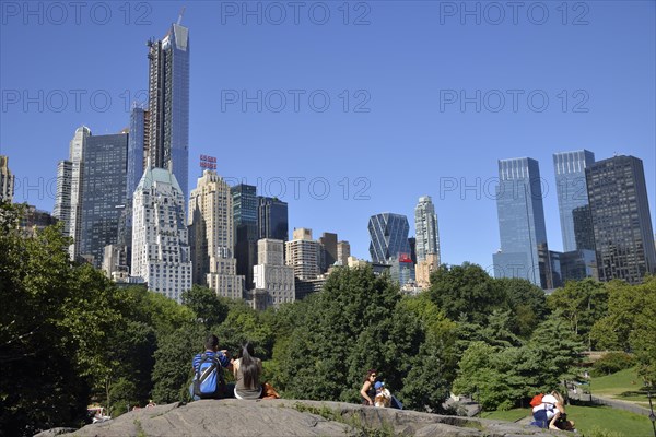 Park visitors with apartment buildings on Central Park South