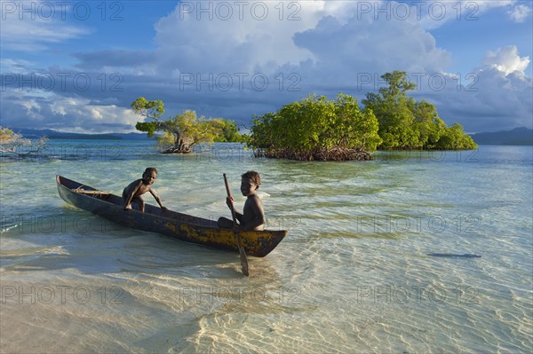 Boys in a canoe in the Marovo Lagoon