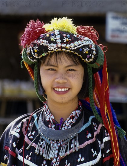 Lisu girl wearing a colourful headdress and the traditional costume of the mountain people