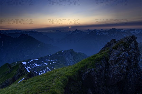 Mountain pasture at sunset with a panoramic view of the mountains