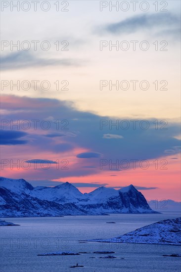Fjord with mountains in winter at sunset