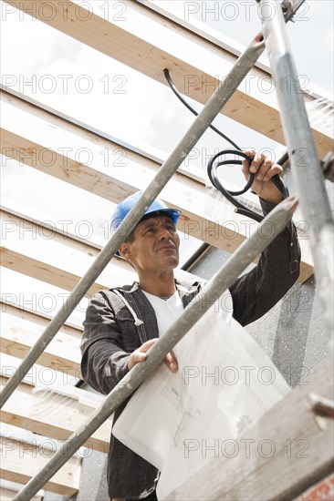 Construction manager controlling the electrical wiring on a construction site