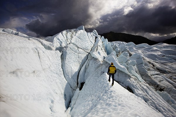 Mountaineer standing in front of crevasses on Matanuska Glacier