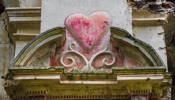 Heart carved in a wall in the ruins of a church