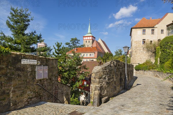 Muhltorgasse street at Fischerpforte gate with the old water tower and St. Michael's Church