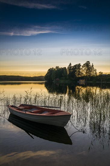 Lake and rowing boat at sunset in Bengtsfors