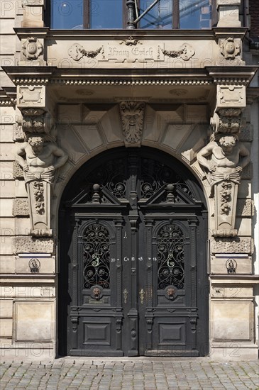 Entrance porch with bay window and atlases