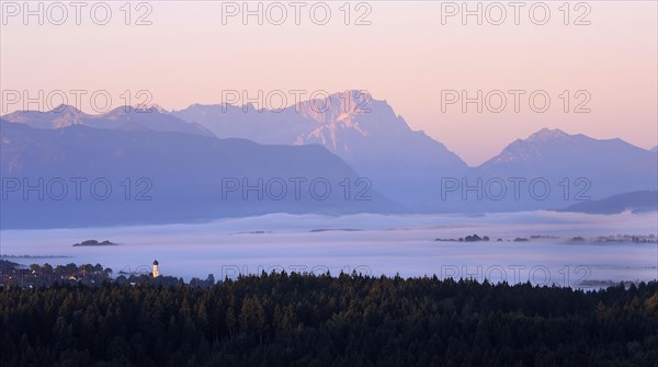 View from Peretshofener Hohe of Konigsdorf and the pre Alps to Zugspitze at sunrise