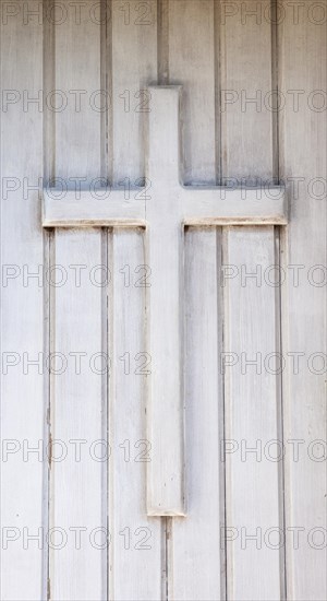 Wooden cross on the front door of a chapel