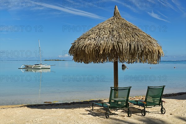 Parasol and sunloungers on the beach