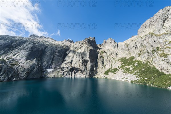Mountain lake Lac de Melo surrounded by cliffs