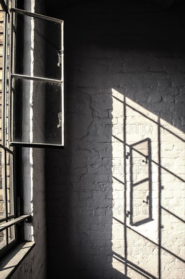 Light reflection of a window in the stairwell of a renovated factory