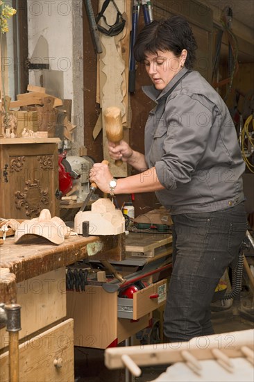 Young farmer carving traditional masks