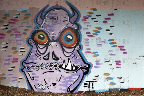 Monster with horns and mouth sewn shut