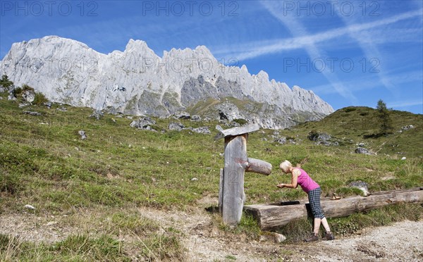 Hiker drinking at a fountain