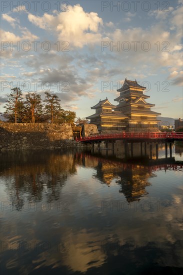 Japanese castle Matsumoto with reflection in the moat
