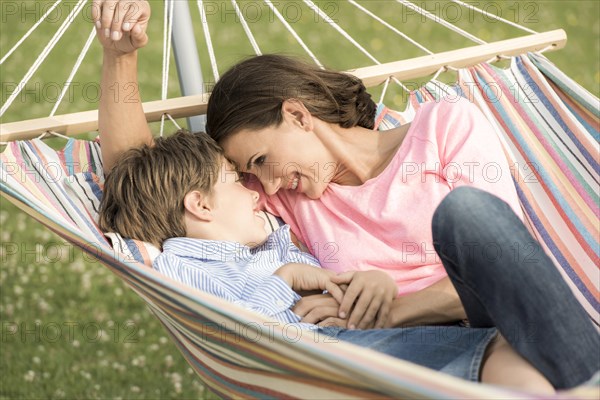 Mother and son lying in hammock