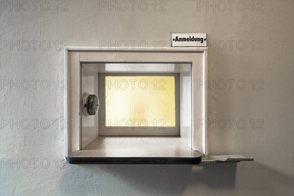 Former front desk with window and bell at an industrial plant