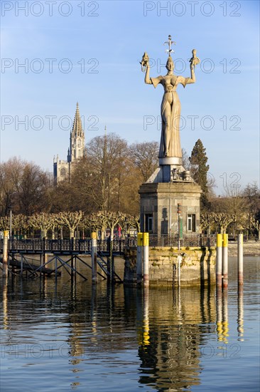 Statue of Imperia at the harbour of Konstanz with Konstanz Cathedral behind