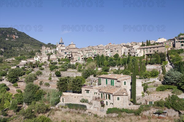 Townscape with Valldemossa Charterhouse and parish church of Sant Bartomeu