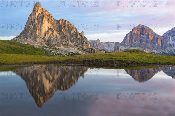 Gusela mountain at sunrise reflected in small lake