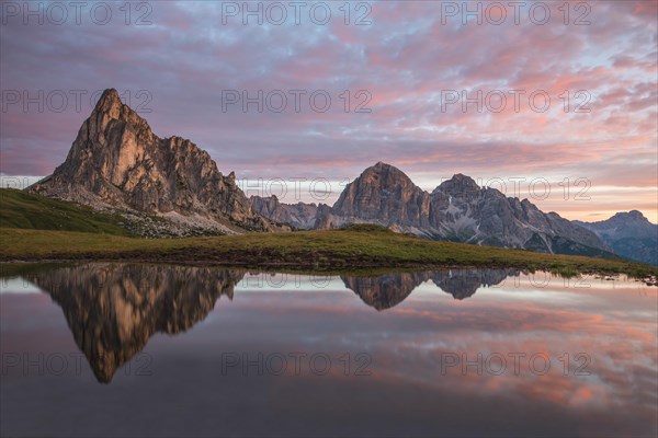 Gusela mountain at sunrise reflected in small lake