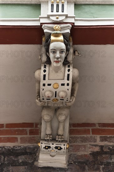 Carved female figure on the wooden balcony of the historic Town Hall