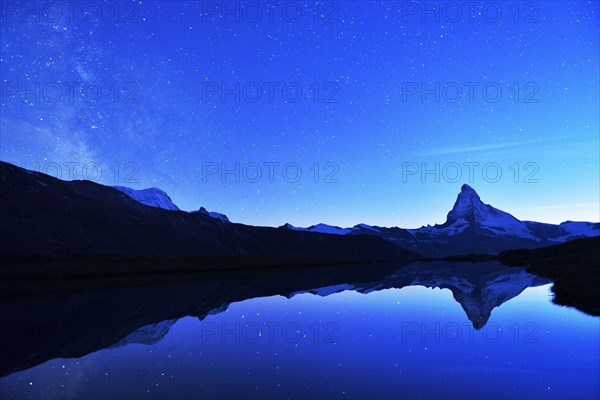 Matterhorn with Milky Way reflected in lake Stellisee