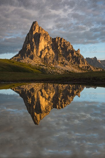 Gusela mountain at sunrise reflected in small lake