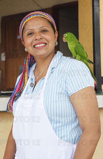 Woman with a parrot on her shoulder