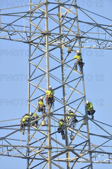 Overhead linemen working on a pylon