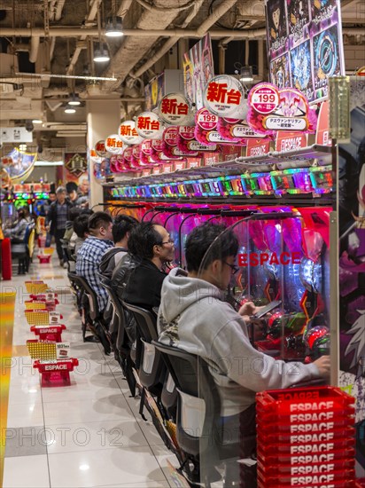 Players sit at slot machines in a casino