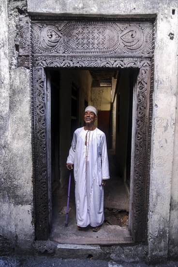 Proud Comorian man standing in doorway